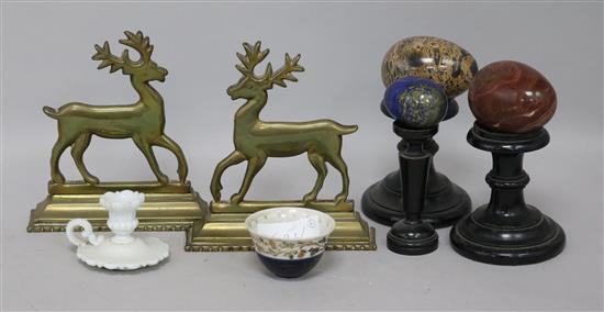 Three hardstone eggs, a pair of brass stag ornaments and a cup on stand
